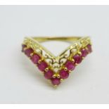 A silver gilt ring set with red stones, O