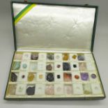 A case of gemstones, in pairs (natural uncut and cut and polished states), sixteen complete sets