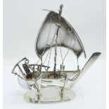 A small silver model of a Dhow, engraved 3M Gulf, Ltd., 57.7g