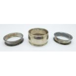 A pair of late Victorian silver napkin rings and one other silver napkin ring, 32.7g
