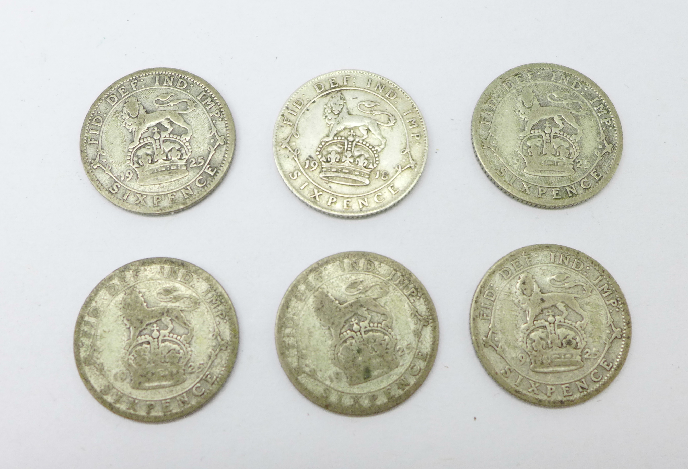 Five 1925 sixpence coins and a 1918 sixpence