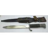 A bayonet with leather frog and metal scabbard