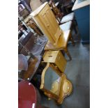 A pine coffee table, corner cabinet, ottoman and mirror