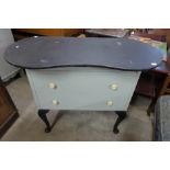 A painted kidney shaped dressing table and a painted cabinet