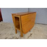 A teak drop-leaf table