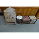 A pine wall cupboard, two stools and a bongo