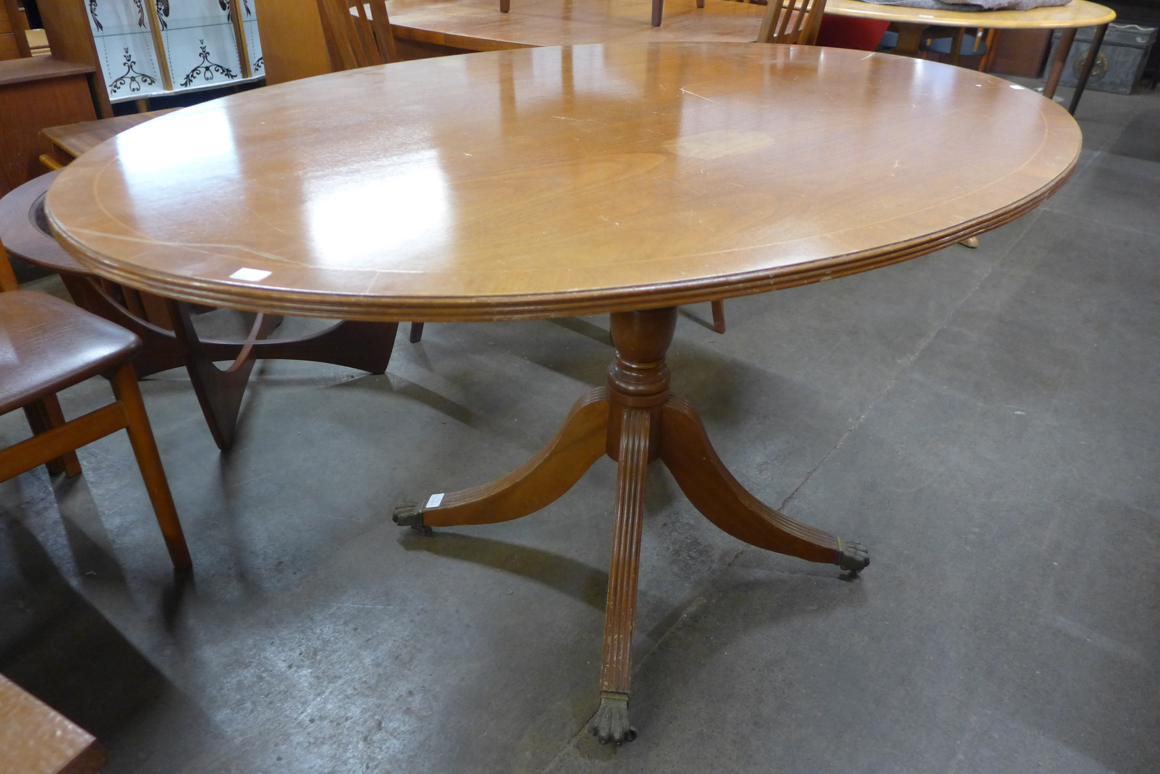 A Regency style inlaid mahogany oval breakfast table