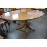 A Regency style inlaid mahogany oval breakfast table