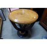 An Art Deco style simulated walnut and ebonised circular occasional table