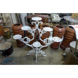 A painted cast metal plant stand