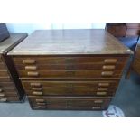 An early 20th Century oak nine drawer plan chest