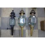 A pair of brass coach lamps and one other
