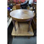 A oak circular table and an oak draw-leaf coffee table