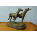 A French style bronze figure of two greyhounds, on black marble plinth, 25cms h