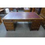 A Victorian style mahogany and red leather topped library desk