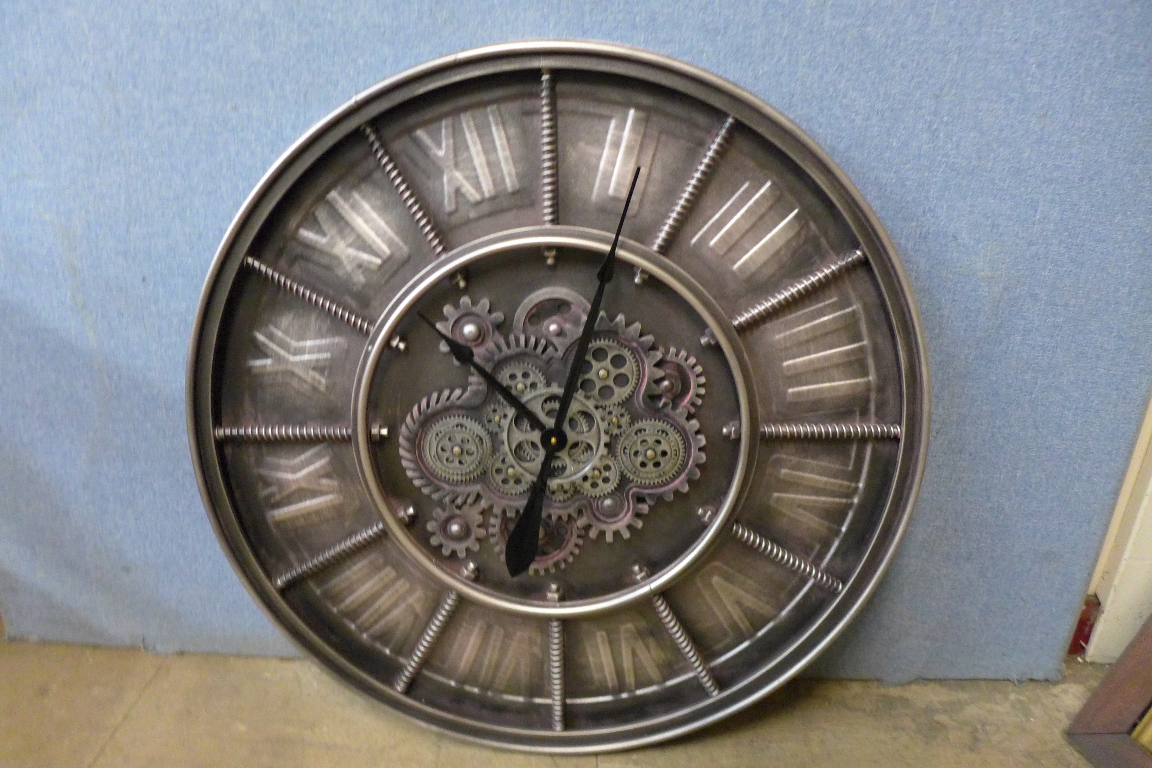 A contemporary circular skeleton wall clock