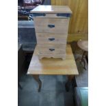 An oak table and a pine bedside chest