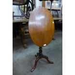 A Victorian walnut oval tilt-top tripod table