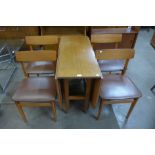 A teak drop-leaf table and four chairs