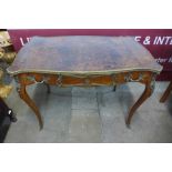 A French Louis XV style mahogany, gilt metal and brown leather topped serpentine writing table