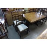 An oak draw-leaf refectory table, four ladderback chairs and a carved oak linenfold dresser