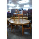 A teak oval extending dining table and four chairs