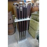 A chrome stick stand and four walking sticks