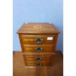 An early 20th Century walnut counter top four drawer haberdashery shop cabinet, bearing J&P Coats