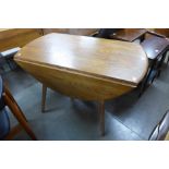 An Ercol Golden Dawn elm and beech drop-leaf table