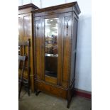 An early 20th Century carved oak single door wardrobe