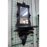 A Black Forest carved wood hall mirror, 93cms h