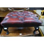 A mahogany and red leather footstool