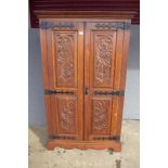 A carved oak two door wardrobe