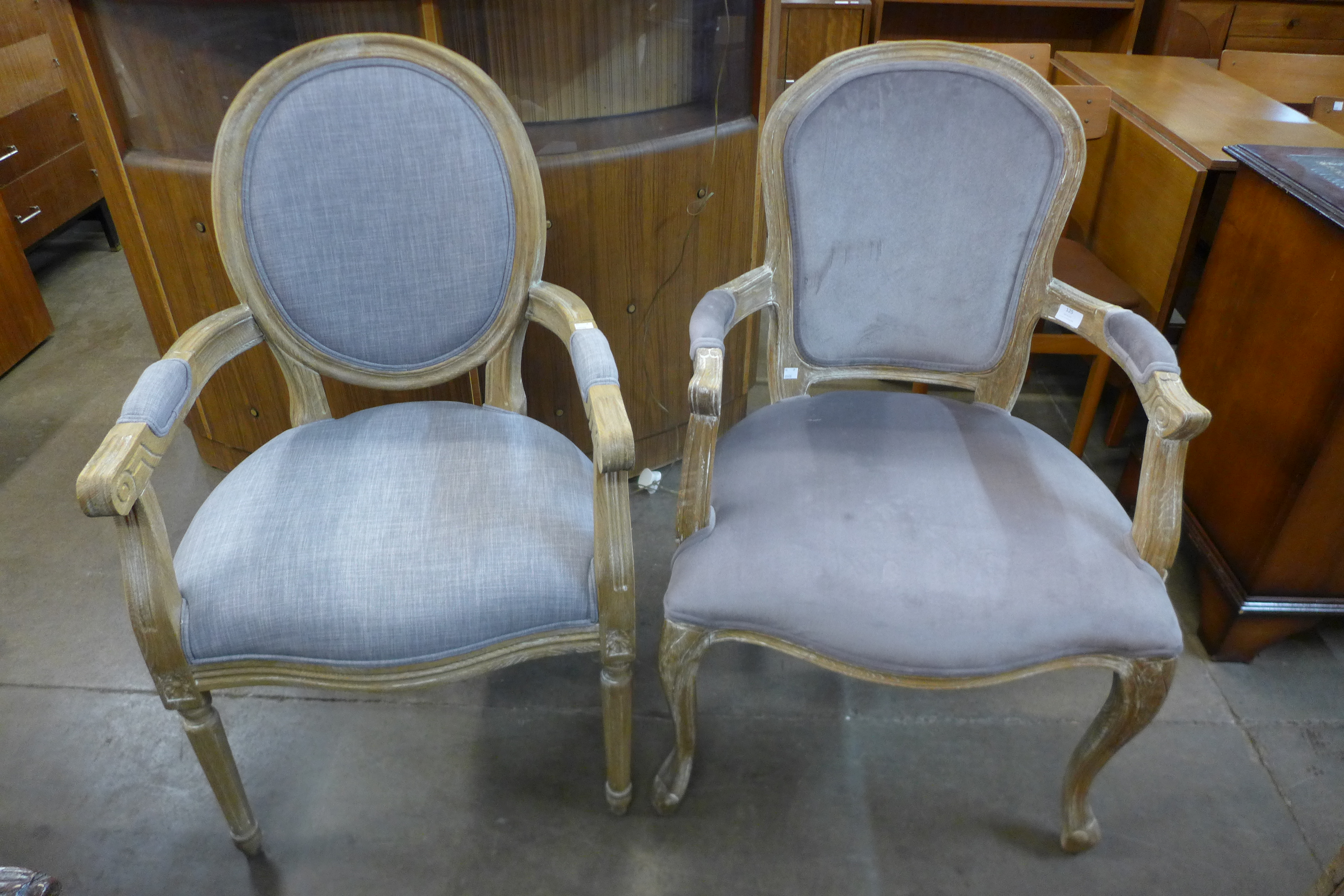 Two similar French style limed oak and upholstered fauteuils