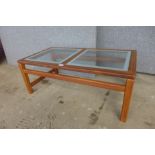 A teak and glass topped coffee table