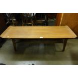 A small folding child's desk and a teak coffee table
