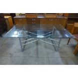 A chrome and glass topped x-frame coffee table