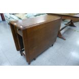 A tola wood and ebonised drop leaf table and an oak drop-leaf table