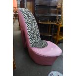 An upholstered stiletto shaped chair