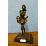 A bronze figure of Marilyn Monroe, on black marble socle, 28cms h