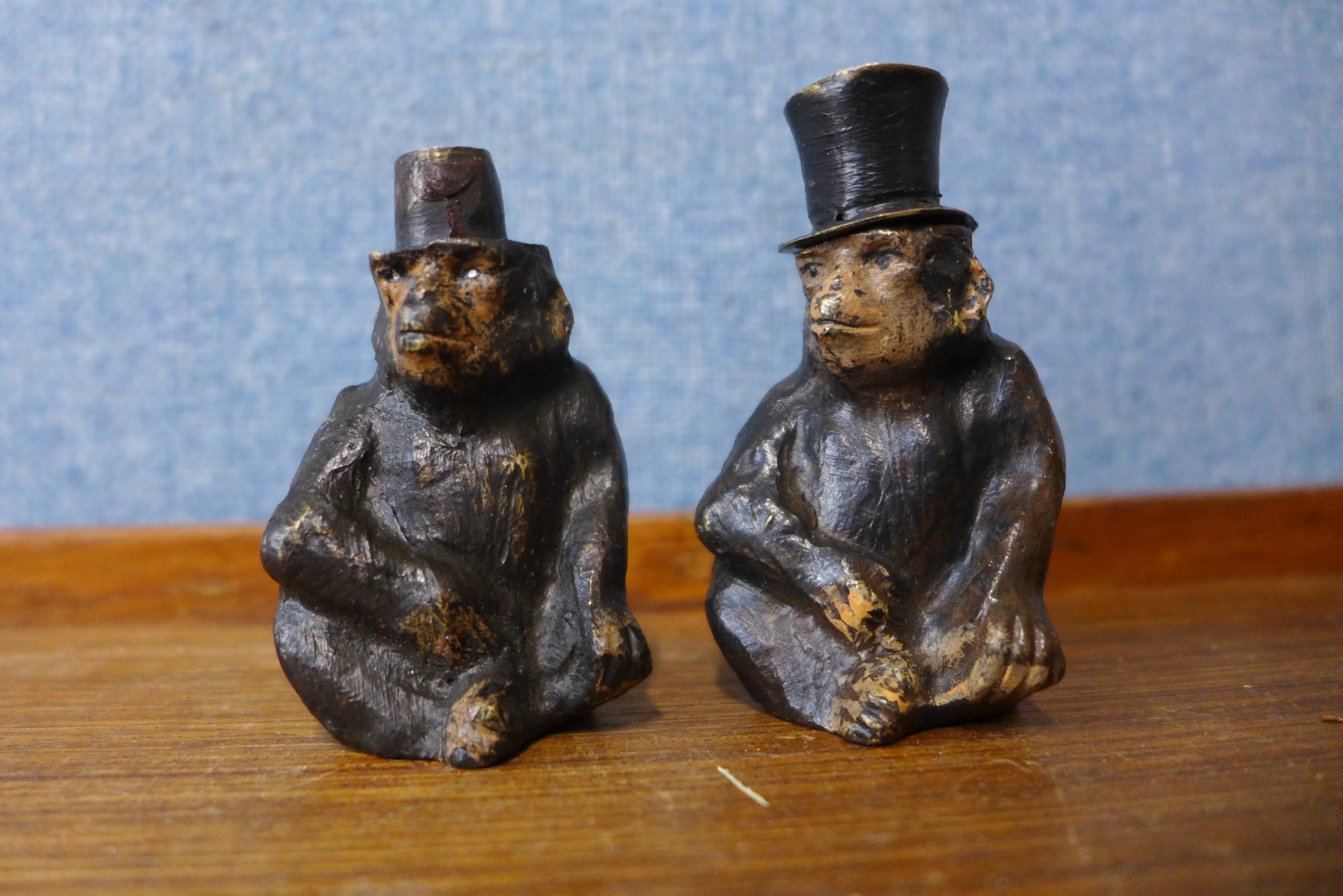 A pair of Austrian cold painted bronze monkey salt and pepperettes, 6.5cms h (one lacking top)