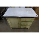 A small enamelled top kitchen cabinet