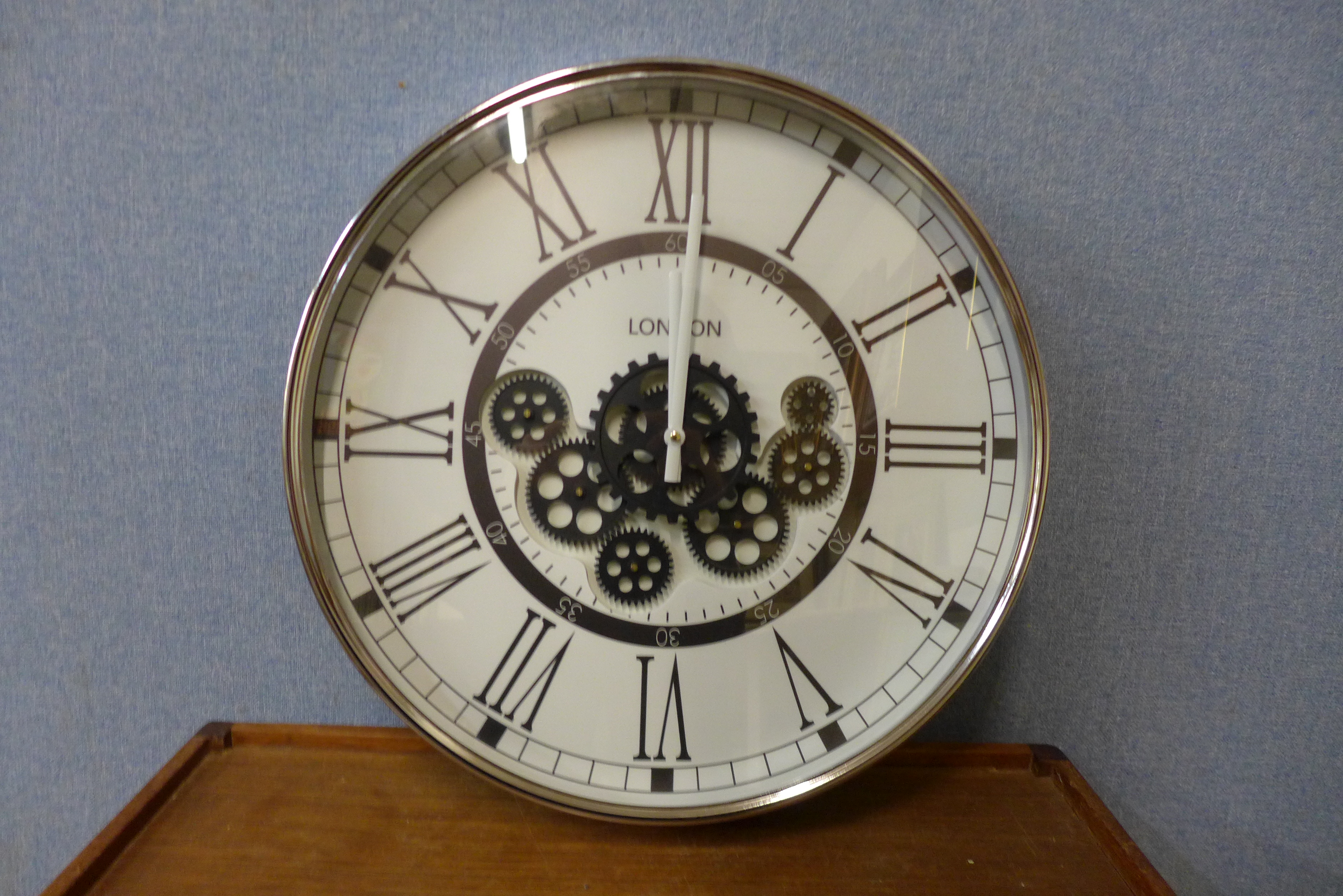 A contemporary circular skeleton wall clock