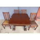 An oak draw leaf table and four chairs