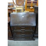 A carved oak bureau