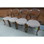 A set of four Victorian walnut balloon back dining chairs