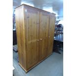 A pine three door wardrobe