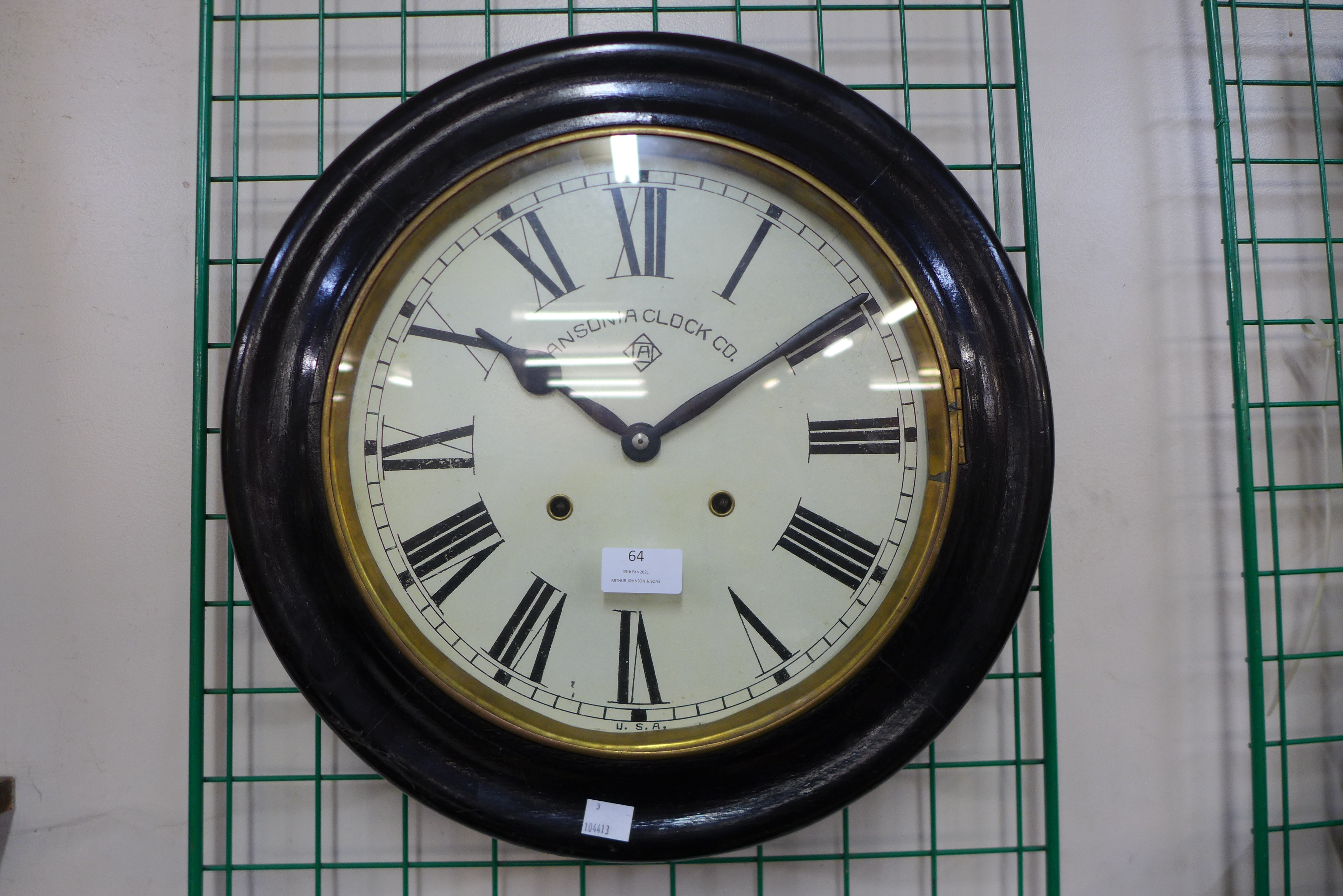 An ebonised circular wall clock, bearing Ansonia Clock Co. inscription to the dial