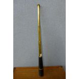 A black leather and brass three draw telescope