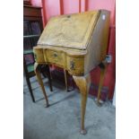 A Queen Anne style figured walnut bureau de dame